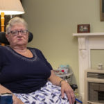 Lyn Bates, 74, sits in her motorised wheelchair in her living room.